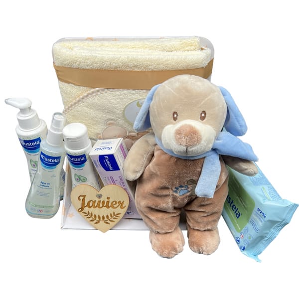 Canastilla Mustela bebé niño con productos de higiene y perrito juguetón.